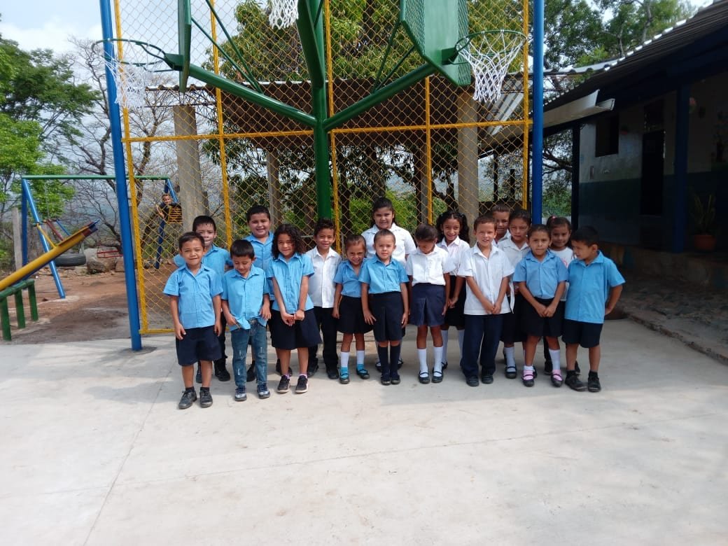 Students in blue uniforms outside their school in Los Horcones
